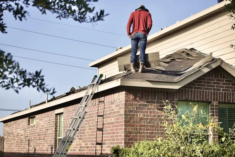 Professional roofer working on a residential roof in Siegel